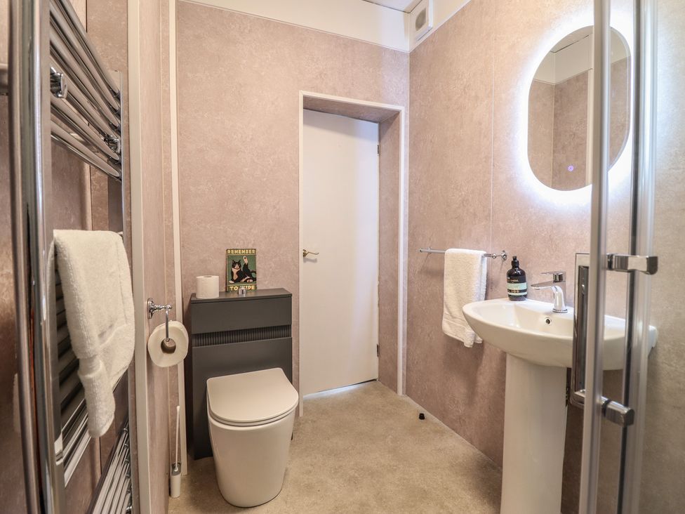 A bathroom with a toilet and sink at Sea View, East Parade in Llandudno