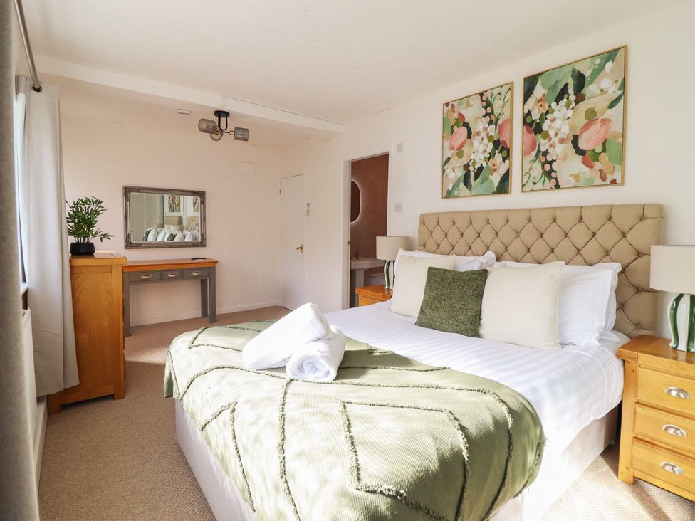 A bedroom with a bed and dressing table at Sea View, East Parade, Llandudno