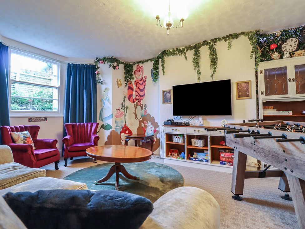 A snug with armchairs and a foosball table at Sea View, East Parade, Llandudno