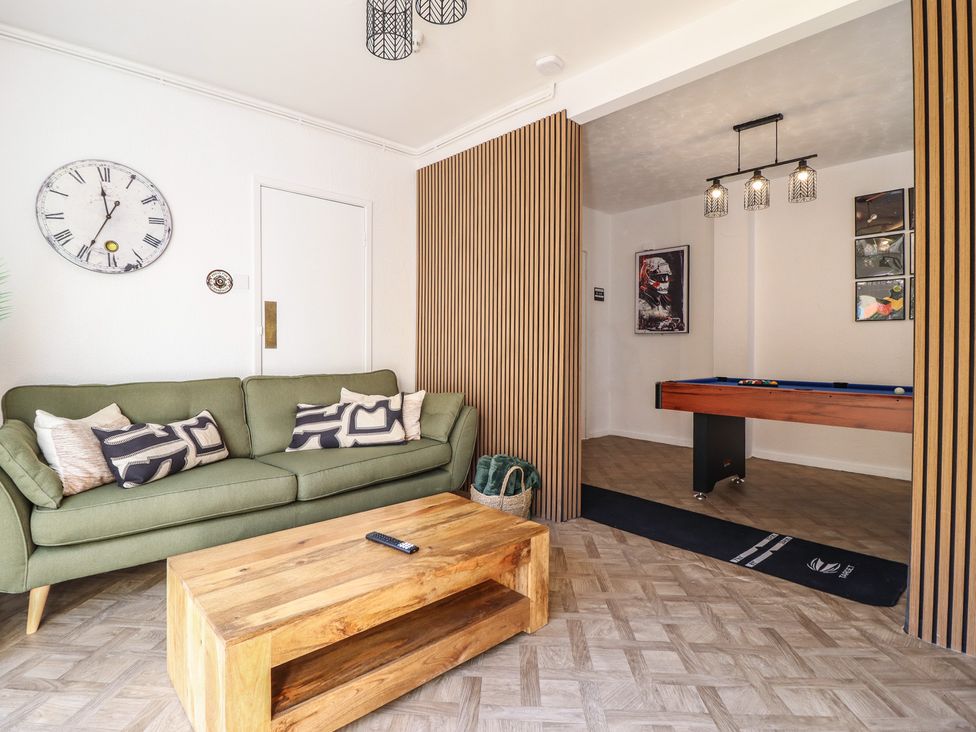 A living room with a sofa and coffee table at Sea View, East Parade Llandudno
