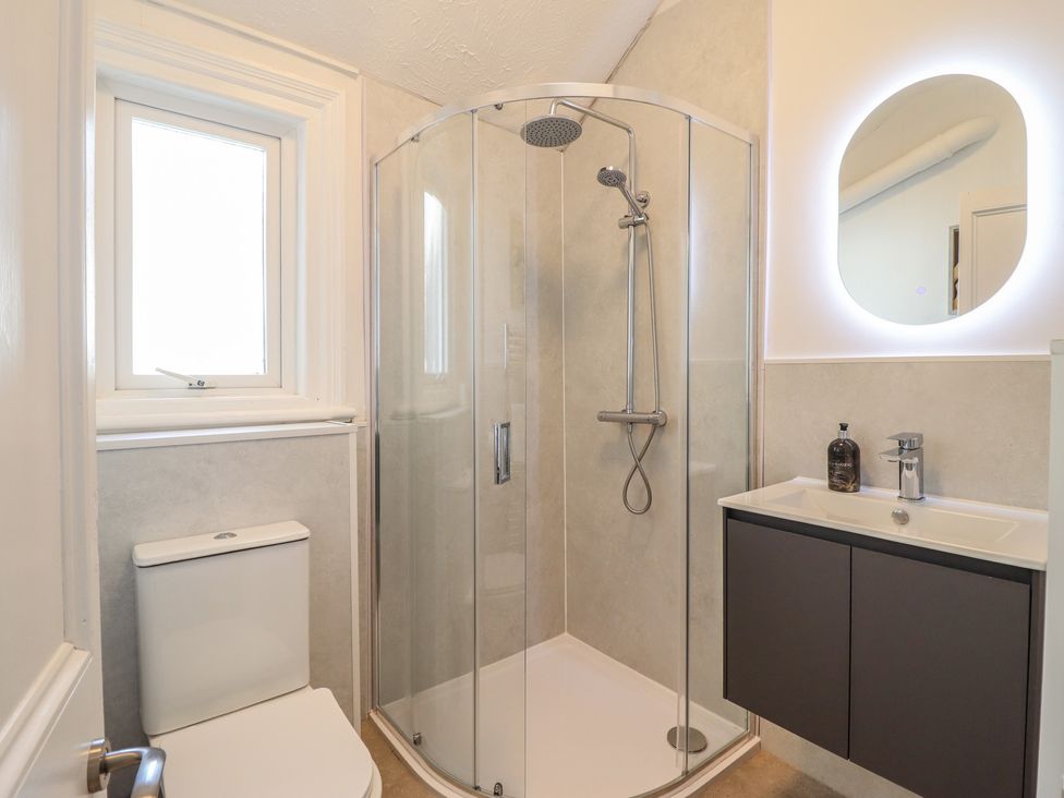 A bathroom with a shower and sink at Sea View, East Parade in Llandudno