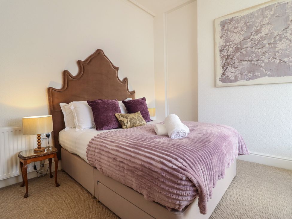 A bedroom with a bed and bedside table at Sea View, East Parade, Llandudno