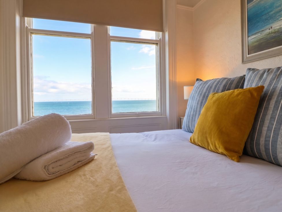 A bedroom with a view of the sea at Sea View, East Parade, Llandudno