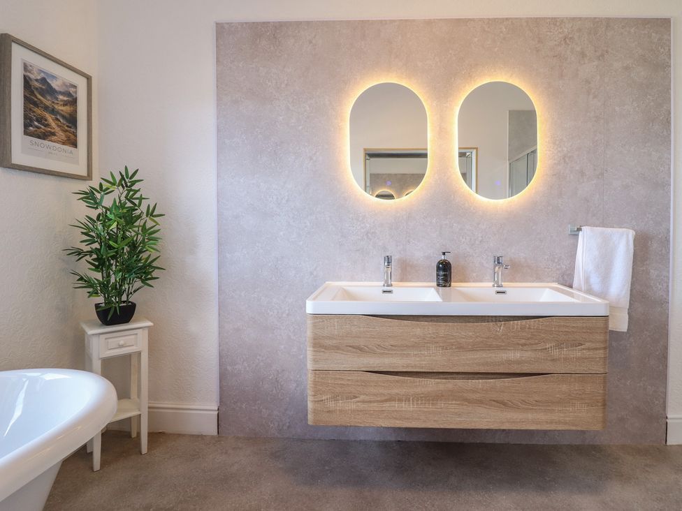 A bathroom with a wash basin and a plant at Sea View, East Parade Llandudno