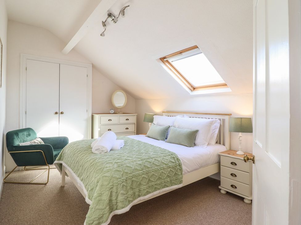 A bedroom with a bed and bedside table at Sea View, East Parade in Llandudno