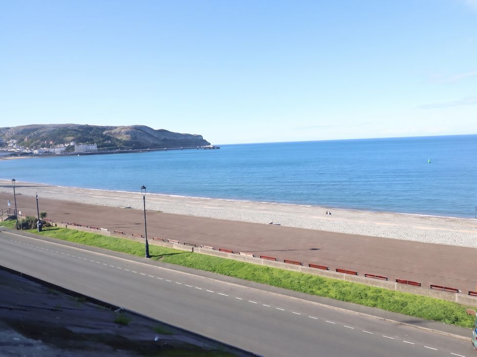 A beach with sea and road at Sea View, East Parade, Llandudno