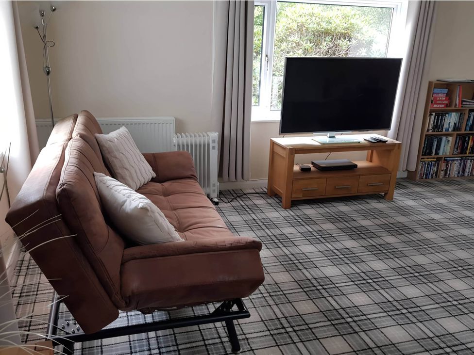 A living room with a sofa and television at River View Cottage Sleeps 6 - Garden, Bbq, Parking in Pitlochry