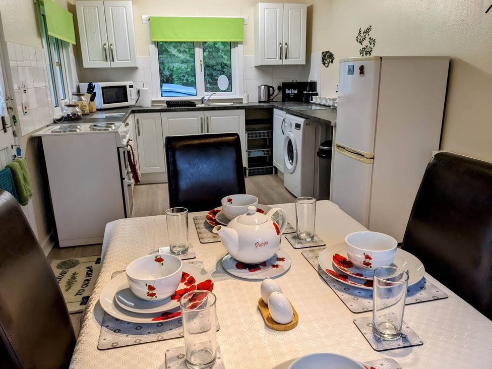 A kitchen with a dining table set at River View Cottage Sleeps 6 - Garden, Bbq, Parking Pitlochry