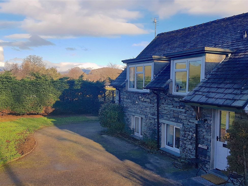 A stone house with windows and a pathway at 3 Bed Barn - Sleeps 6 - Parking - Wifi in Hawkshead