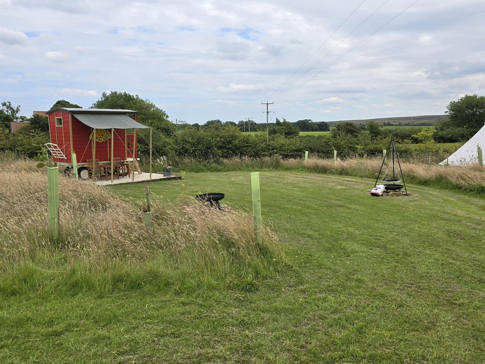 A red wagon with furniture in front of it at Restored circus wagon Saltburn-By-The-Sea