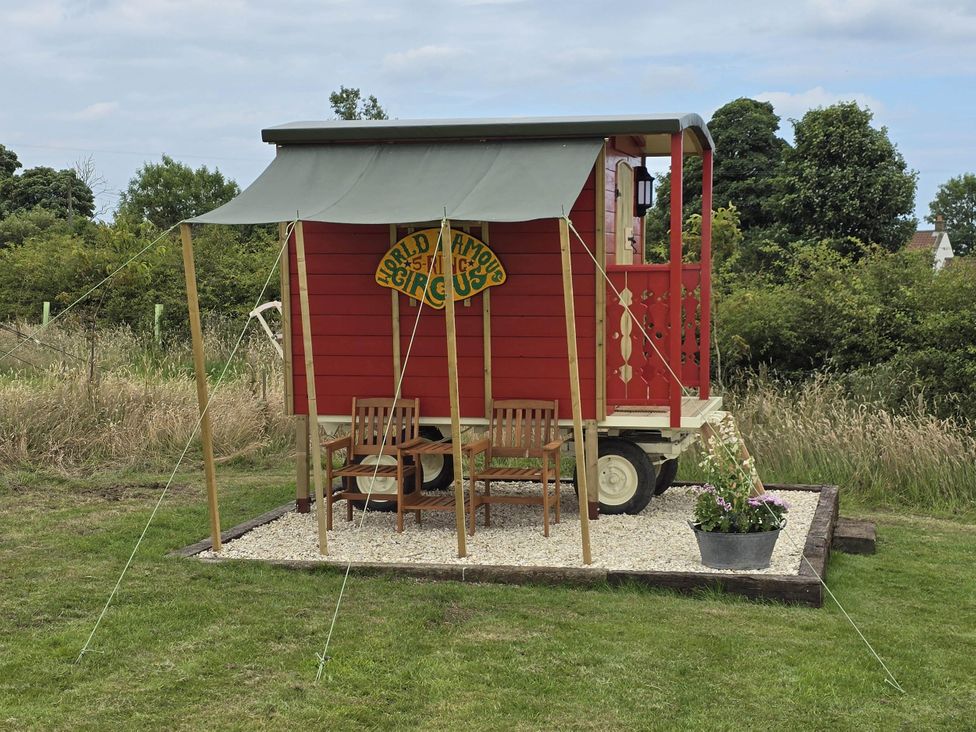 A circus wagon with seating and a planter at Restored circus wagon in Saltburn-By-The-Sea