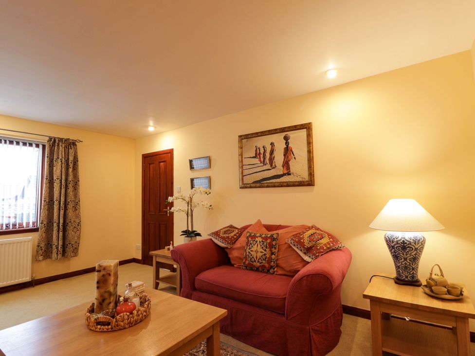 A living room with a sofa and coffee table at Dunhallin House in Inverness