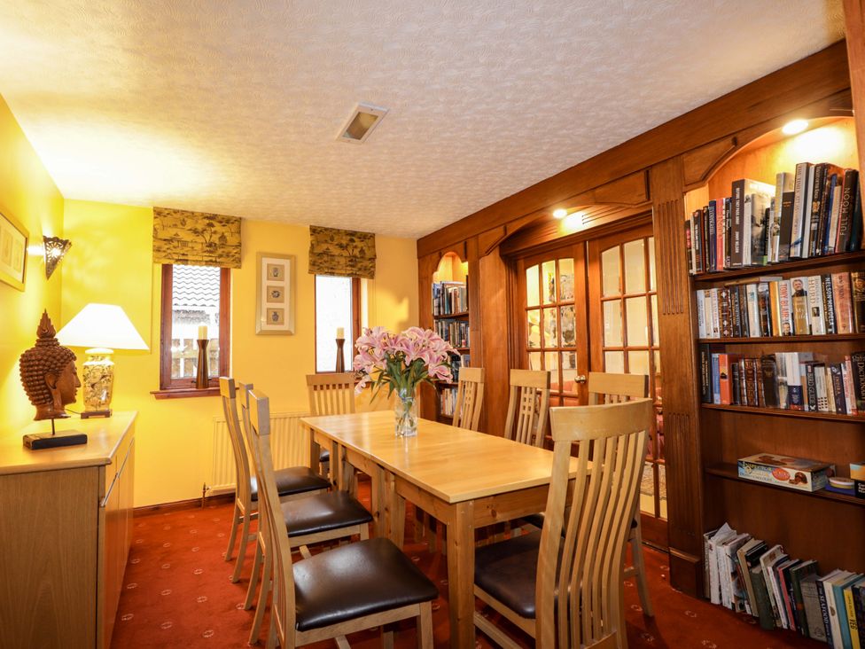 A dining room with a table and chairs at Dunhallin House in Inverness