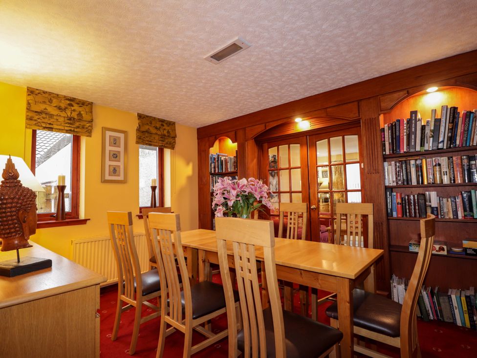 A dining room with a table and chairs at Dunhallin House in Inverness