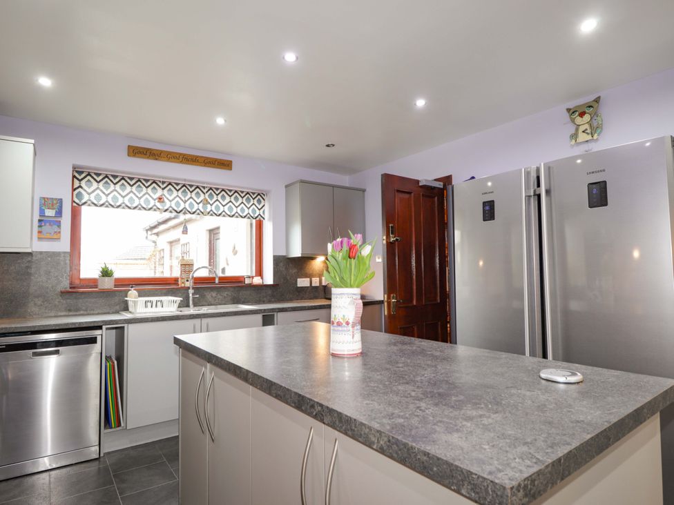 A kitchen with a sink and two refrigerators at Dunhallin House in Inverness