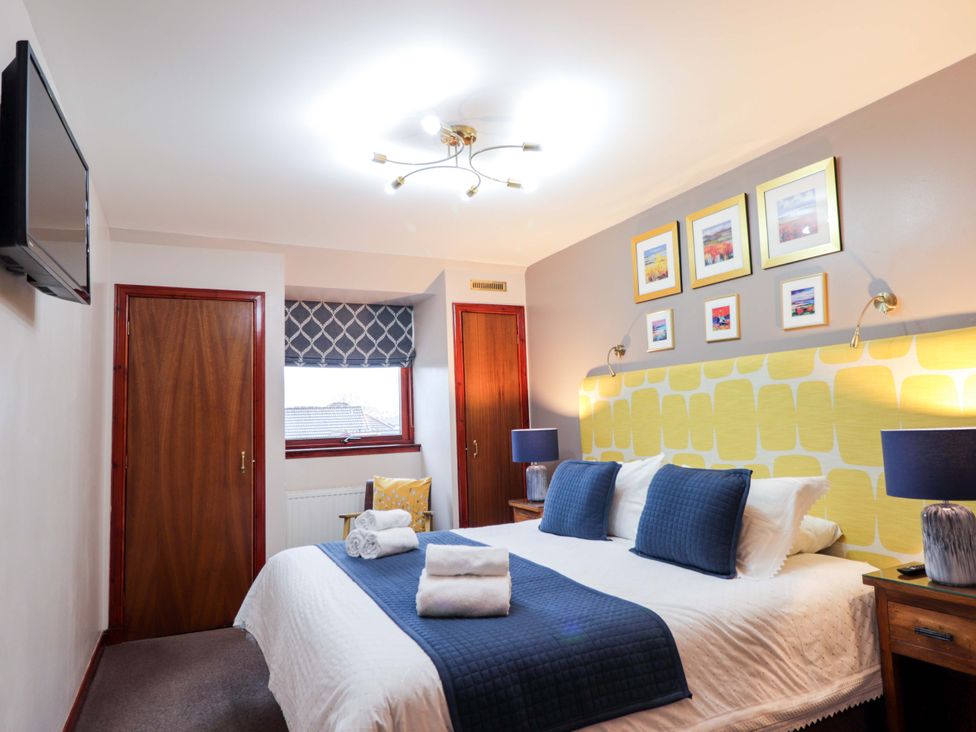 A bedroom with a television and double bed at Dunhallin House in Inverness