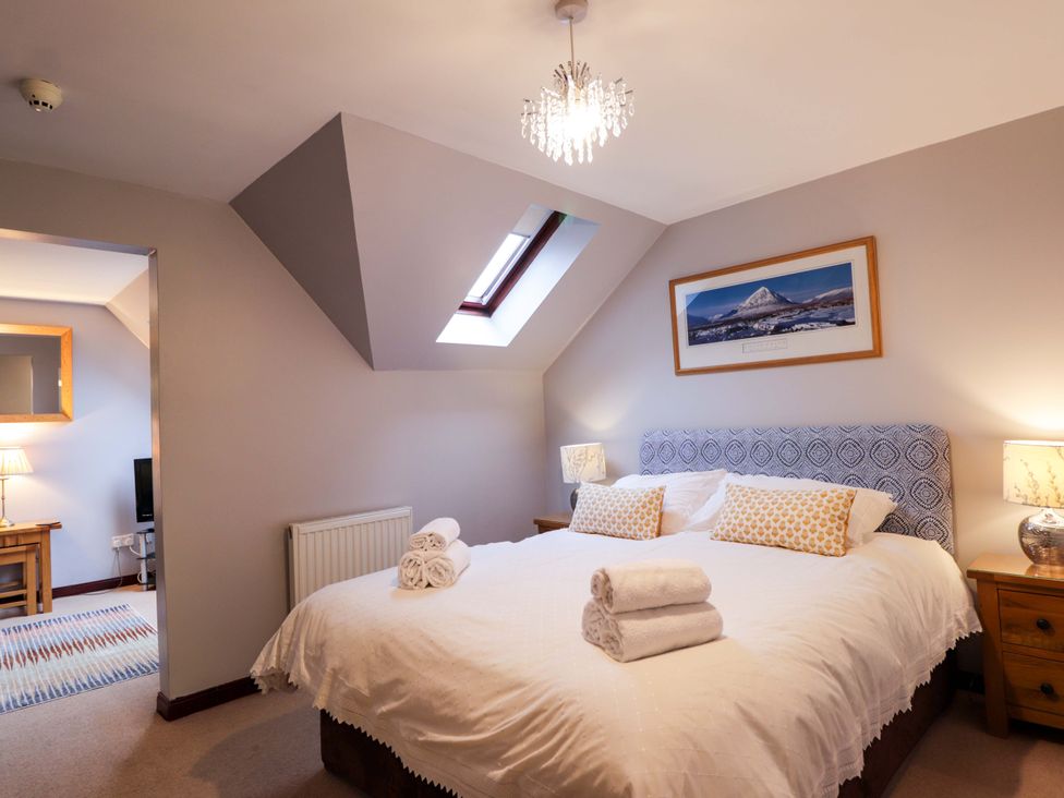 A bedroom with a double bed and bedside lamps at Dunhallin House in Inverness