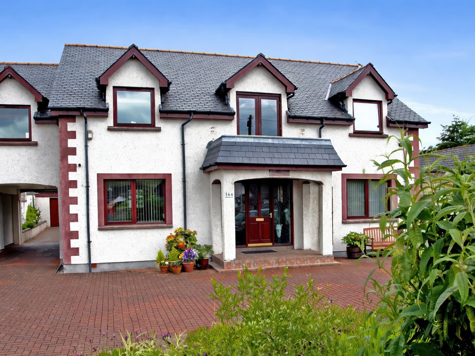 A house with a front door and flower pots at Dunhallin House in Inverness