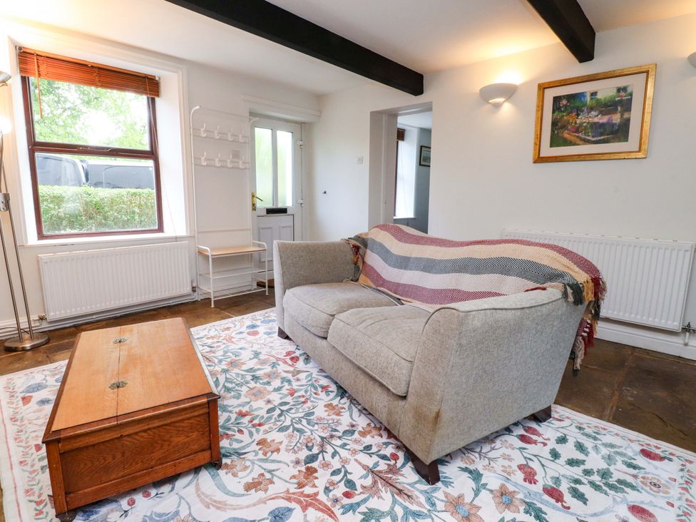 A living room with a sofa and coffee table at 6 Hazel Moor in Blackburn