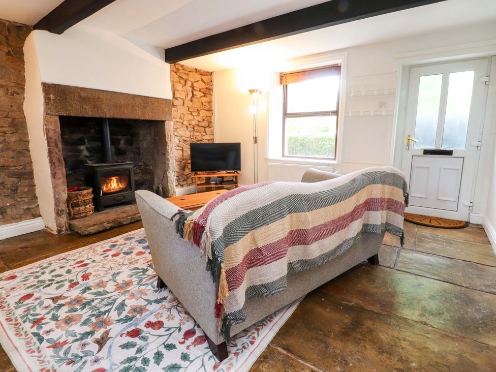 A living room with a sofa and fireplace at 6 Hazel Moor in Blackburn
