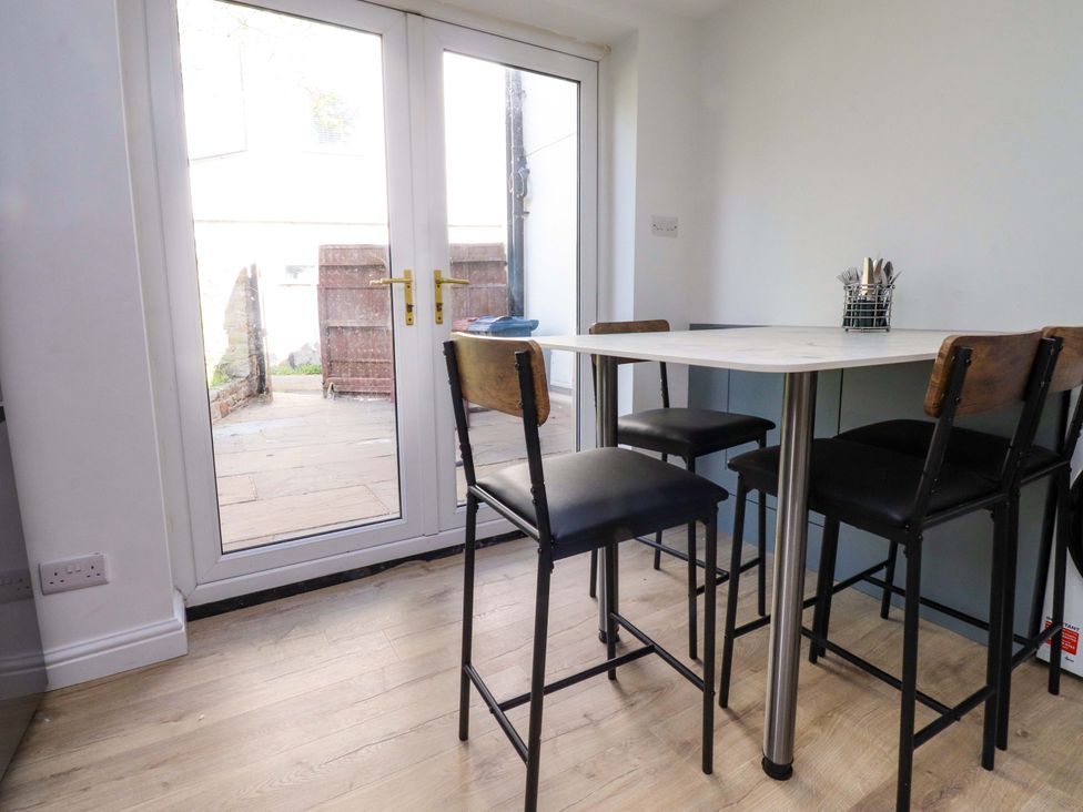 A dining room with a table and chairs at 6 Hazel Moor Blackburn