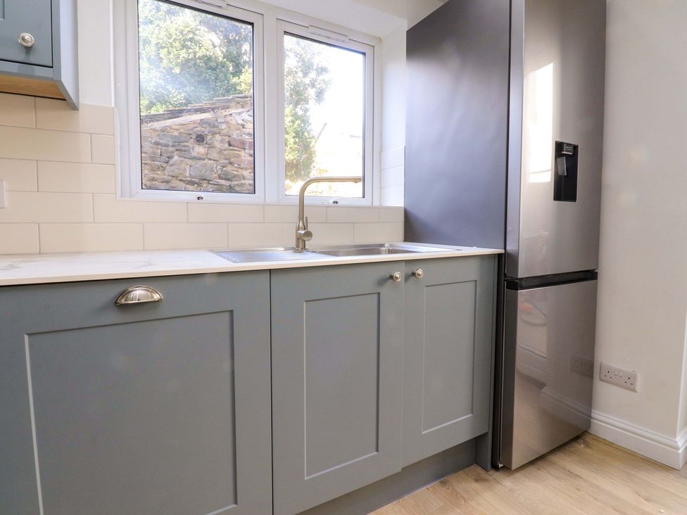 A kitchen with sink and refrigerator at 6 Hazel Moor Blackburn