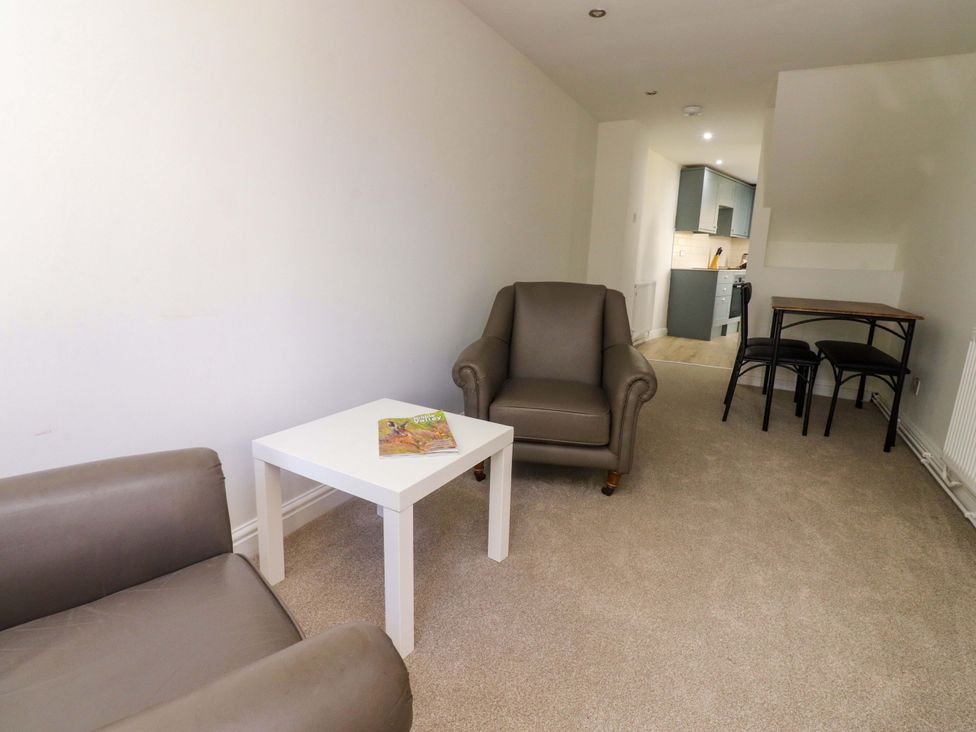 A living room with an armchair and a table at 6 Hazel Moor Blackburn