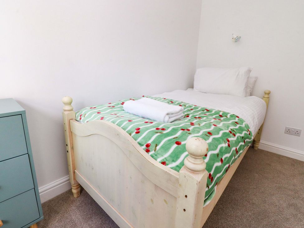 A bedroom with a single bed and nightstand at 6 Hazel Moor Blackburn