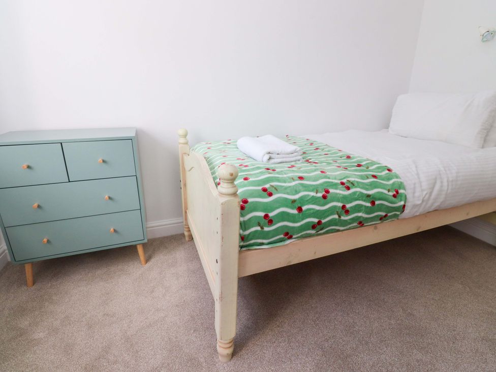 A bedroom with a bed and a drawer at 6 Hazel Moor Blackburn