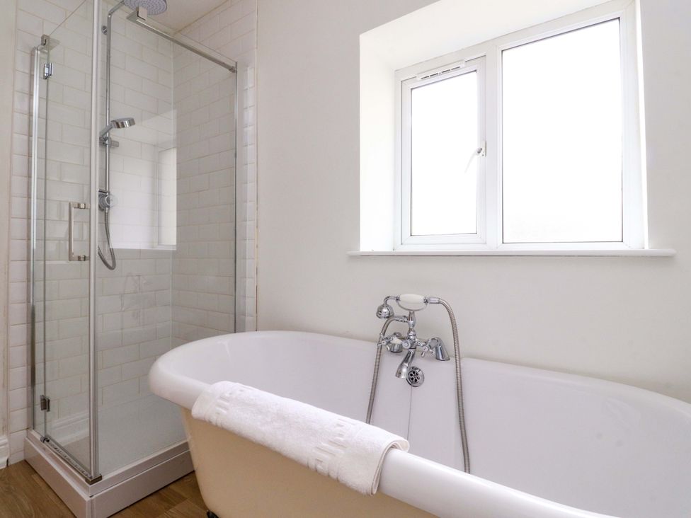 A bathroom with a bathtub and shower at 6 Hazel Moor Blackburn