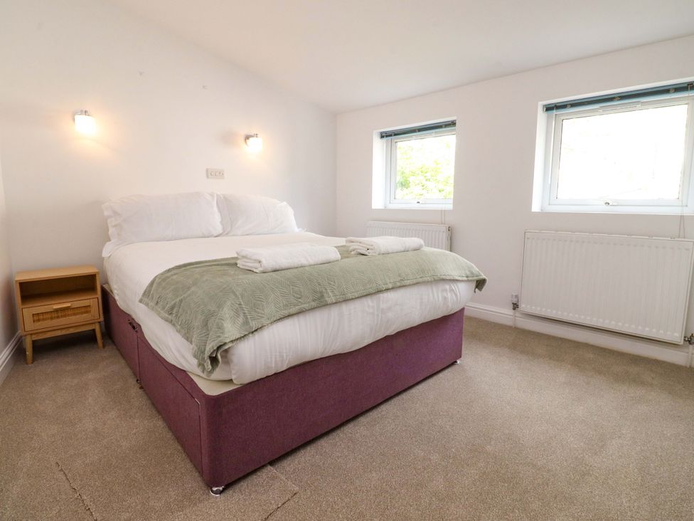A bedroom with a bed and nightstand at 6 Hazel Moor Blackburn