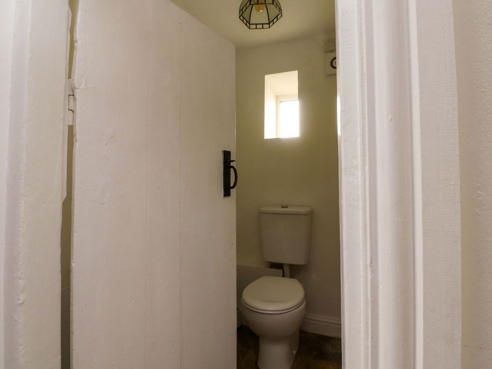 A bathroom with a toilet and a window at 6 Hazel Moor Blackburn