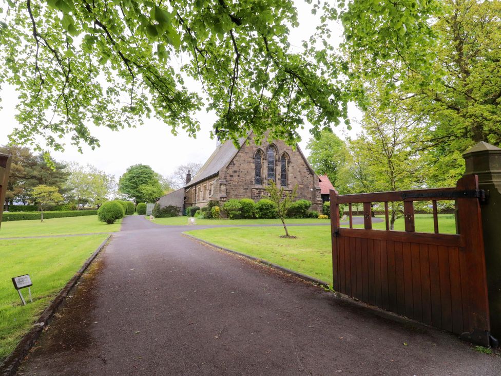 A pathway leading to a church with a gate at 6 Hazel Moor Blackburn