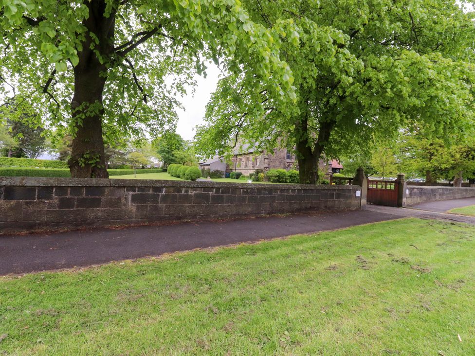 An outdoor view of a pathway and greenery at 6 Hazel Moor in Blackburn