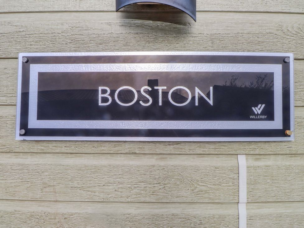 A sign reading BOSTON with Willerby logo on the wall