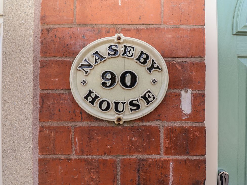 A house sign with 'Naseby House' and number 90 at Naseby House in Morton near Alfreton