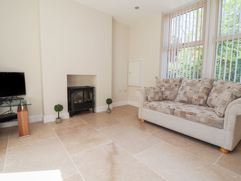 A living room with a television and sofa at Naseby House Morton near Alfreton