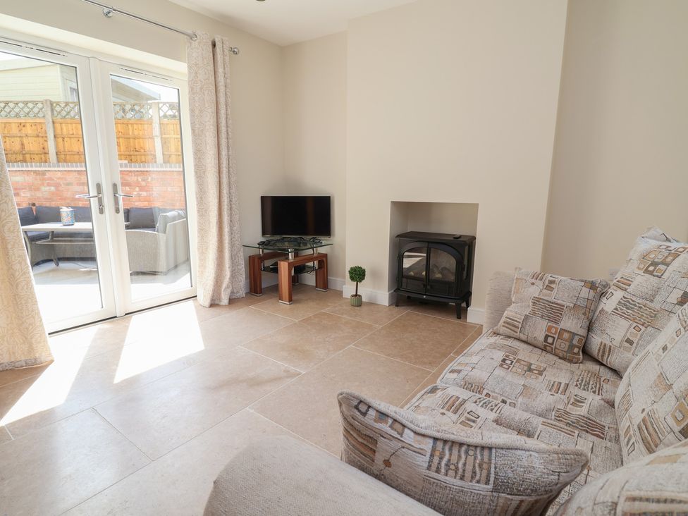 A living room with a sofa and television at Naseby House in Morton near Alfreton