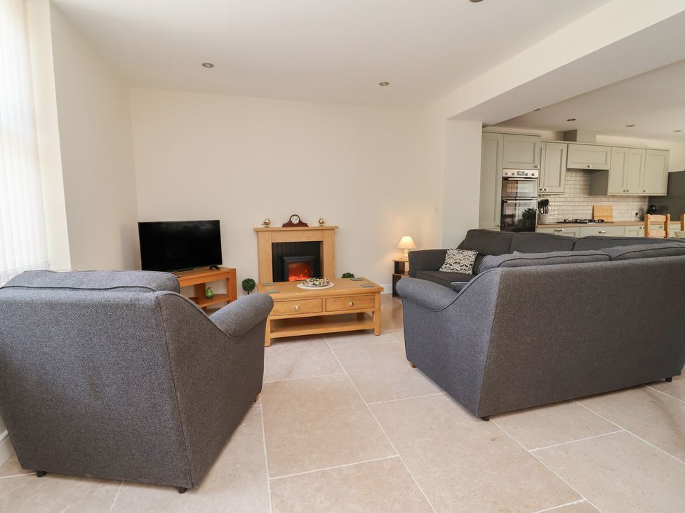 A living room with a sofa and television at Naseby House in Morton near Alfreton