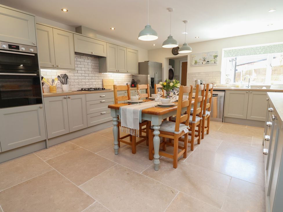 A kitchen with dining table and seating at Naseby House in Morton near Alfreton