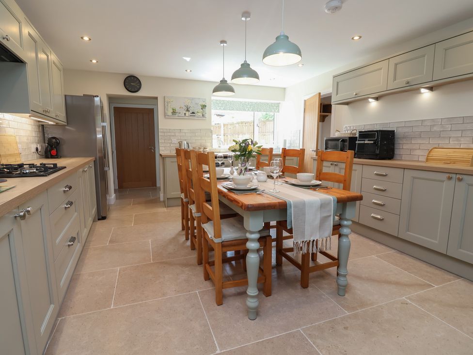 A kitchen with a dining table and chairs at Naseby House in Morton near Alfreton