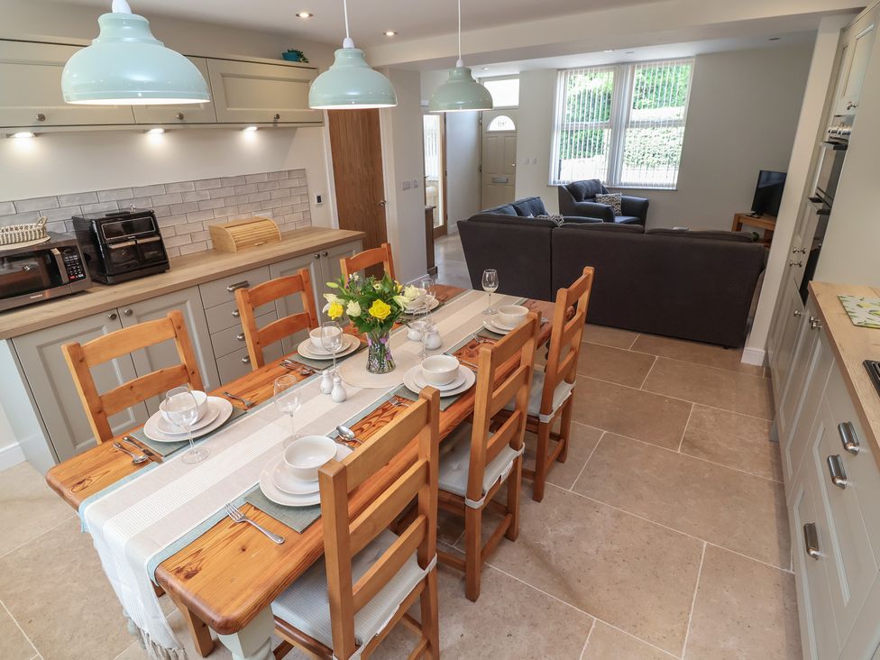 A dining room with a table set for a meal at Naseby House in Morton near Alfreton