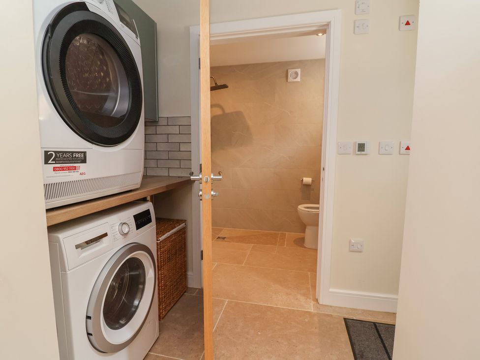 A laundry room with washing machine and dryer at Naseby House Morton near Alfreton