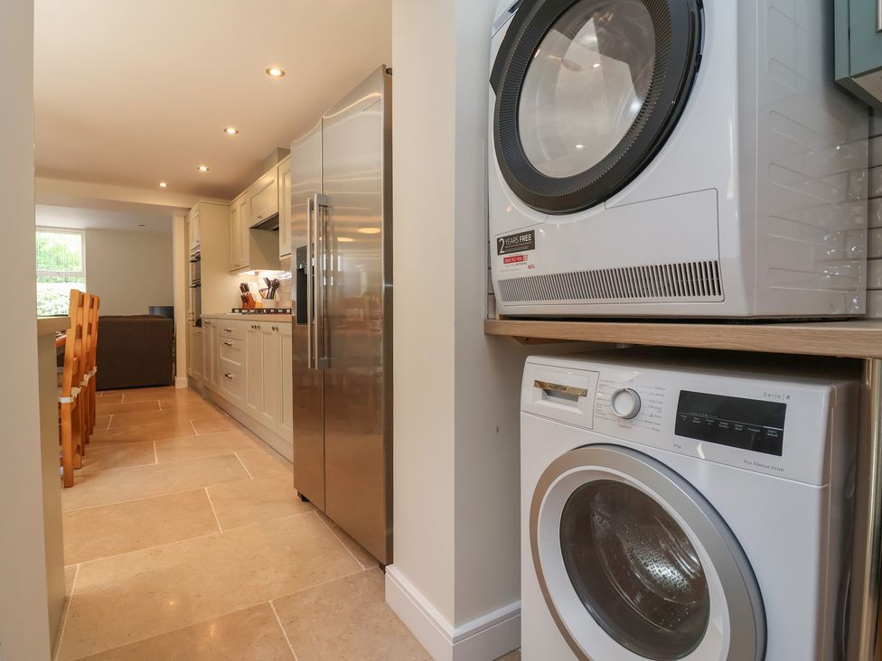 A kitchen with a washing machine and tumble dryer at Naseby House Morton near Alfreton