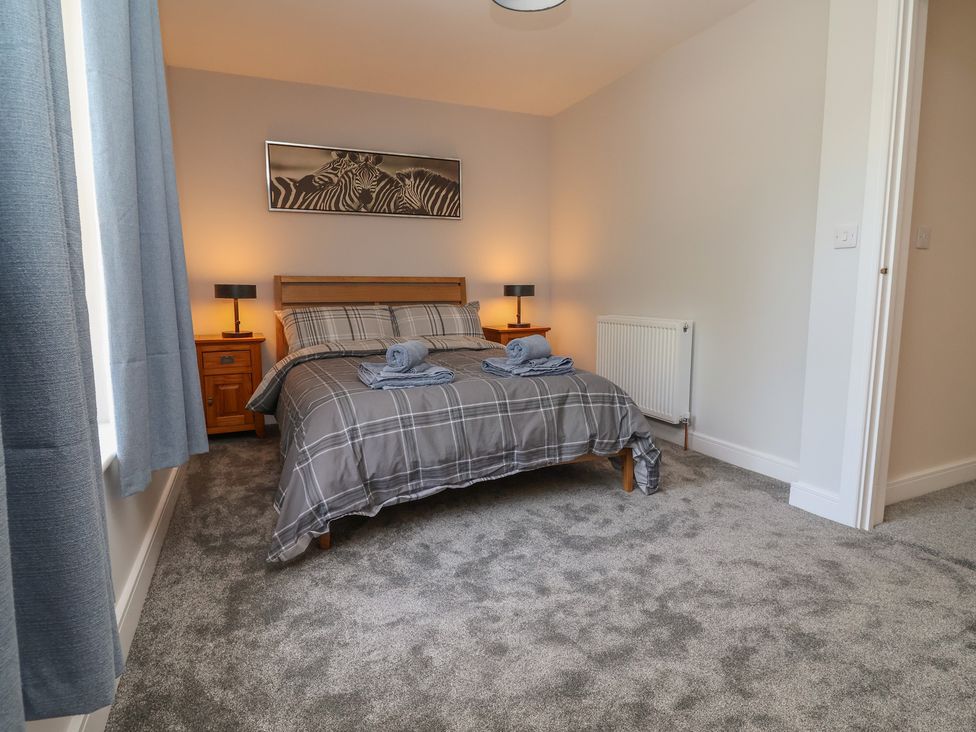 A bedroom with a bed and nightstands at Naseby House Morton near Alfreton