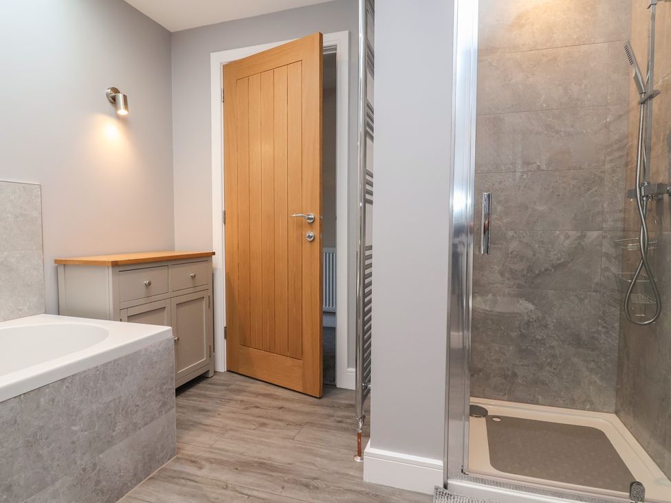 A bathroom with a bathtub and shower at Naseby House Morton near Alfreton