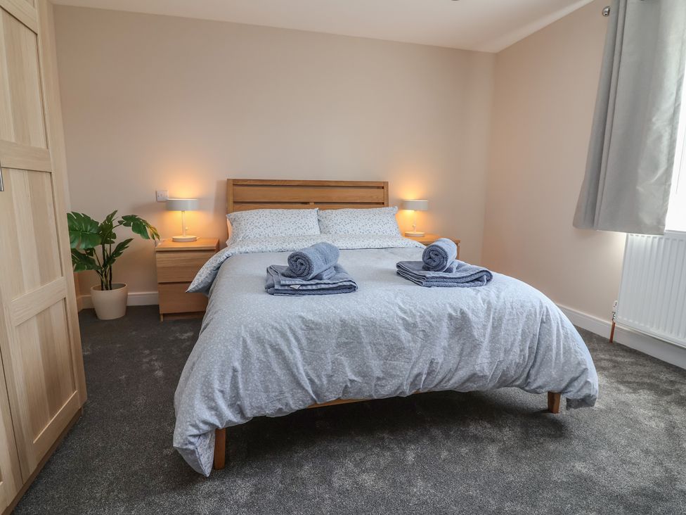 A bedroom with a bed and towels on it at Naseby House Morton near Alfreton