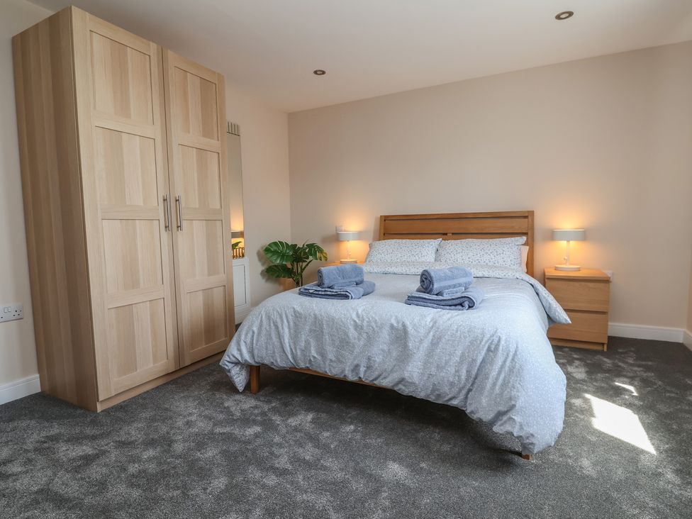 A bedroom with a bed and wardrobe at Naseby House in Morton near Alfreton