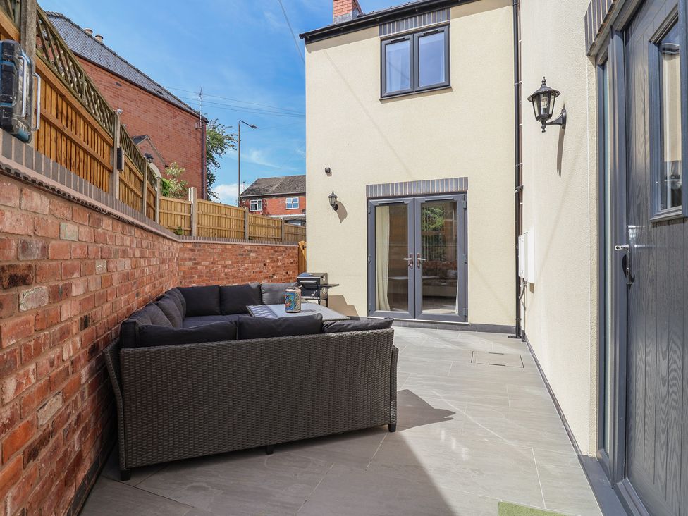 An outdoor patio area with a sofa and table at Naseby House Morton near Alfreton