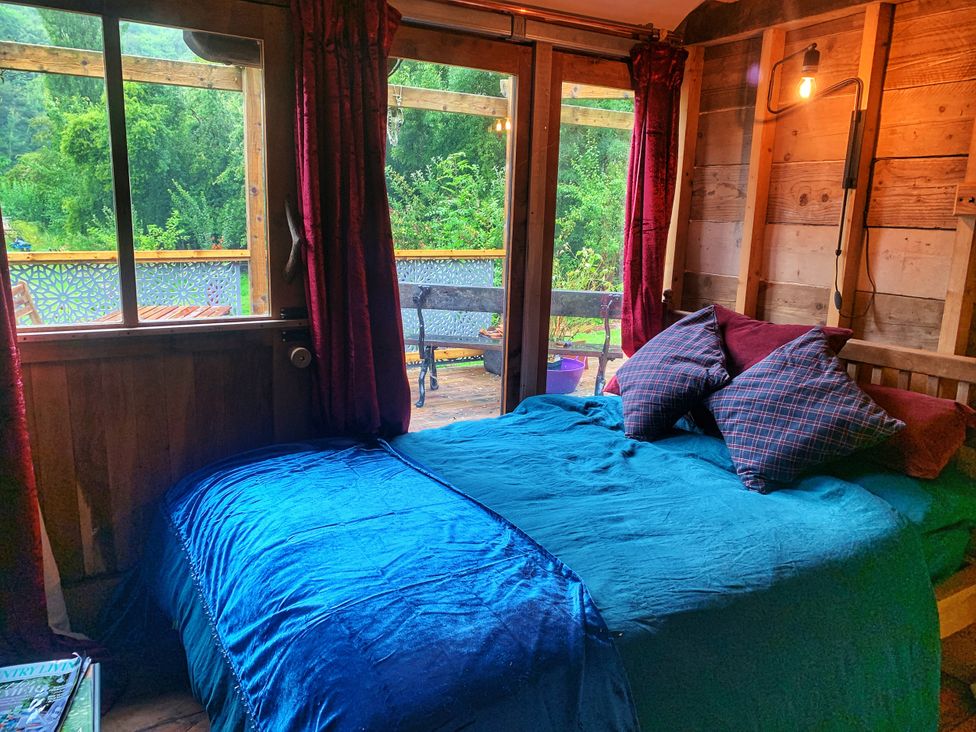 A bedroom with a bed and pillows at Ferryman's Lodge in Brockweir